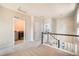 Second floor hallway with carpet, access to laundry and multiple rooms at 6940 Clay St, Denver, CO 80221