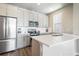 Modern kitchen with stainless steel appliances, quartz countertops, and ample cabinet space at 6940 Clay St, Denver, CO 80221