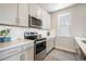 Modern kitchen with stainless steel appliances and white subway tile at 6940 Clay St, Denver, CO 80221