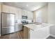 Bright modern kitchen with stainless steel appliances and gray cabinets at 6940 Clay St, Denver, CO 80221