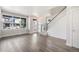 Bright and airy living room featuring hardwood floors, large windows, and a staircase leading upstairs at 6940 Clay St, Denver, CO 80221