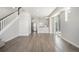 Open-concept living room featuring hardwood floors, white walls, and staircase, leading to modern kitchen at 6940 Clay St, Denver, CO 80221