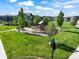 Neighborhood playground with a swing set, a slide, mature trees, and green grass at 6940 Clay St, Denver, CO 80221