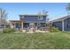 Spacious backyard with a patio, outdoor seating, and lush green lawn at 8007 S Dover St, Littleton, CO 80128