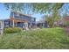 Expansive backyard featuring a well-maintained lawn and patio with outdoor furniture at 8007 S Dover St, Littleton, CO 80128