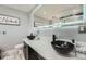 Modern bathroom showcasing sleek black vessel sinks and a large, illuminated mirror at 8007 S Dover St, Littleton, CO 80128