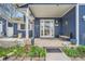 Inviting covered front porch with chairs, decor, and charming details offering a warm welcome at 8007 S Dover St, Littleton, CO 80128