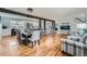 Bright living space with hardwood floors, dining table, kitchen with island and stainless appliances at 8007 S Dover St, Littleton, CO 80128