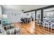 Open-concept living space with hardwood floors, dining area and stylish kitchen with bar seating at 8007 S Dover St, Littleton, CO 80128