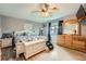 Comfortable main bedroom featuring a ceiling fan, wood floors, and a large dresser at 8007 S Dover St, Littleton, CO 80128