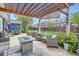 Inviting patio area with fire pit and comfortable seating under a wooden pergola at 8007 S Dover St, Littleton, CO 80128