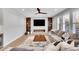 Cozy living room with a fireplace, hardwood floors, and large windows at 359 Castlemaine Ct, Castle Rock, CO 80104