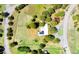 A bird's eye view displays the entire property: lush lawn, many trees, and surrounding roads at 21868 Mountsfield Dr, Golden, CO 80401