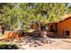 Relaxing backyard featuring a hot tub, mature trees, patio, and outdoor seating with a park-like atmosphere at 21868 Mountsfield Dr, Golden, CO 80401