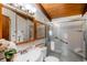 Bright bathroom with glass shower, vanity with storage and ample lighting at 21868 Mountsfield Dr, Golden, CO 80401