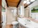 Bathroom featuring wood accents, glass shower and a pedestal sink at 21868 Mountsfield Dr, Golden, CO 80401