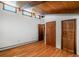 Bedroom with hardwood floors, exposed beams, wood doors and ample natural light at 21868 Mountsfield Dr, Golden, CO 80401