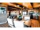 Open floor plan with dining table and chairs and kitchen nearby at 21868 Mountsfield Dr, Golden, CO 80401