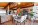 Dining room area features wood dining table, tile floor, and is adjacent to kitchen at 21868 Mountsfield Dr, Golden, CO 80401