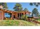 Charming brick home featuring a deck, outdoor seating, and manicured lawn, perfect for relaxing outdoors at 21868 Mountsfield Dr, Golden, CO 80401