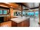 Open concept home with kitchen island leading into living area and picturesque mountain view at 21868 Mountsfield Dr, Golden, CO 80401