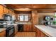 Well-equipped kitchen boasts wood cabinets, black appliances, and adjacent dining space at 21868 Mountsfield Dr, Golden, CO 80401