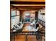 Comfortable living room with brick walls, a cozy fireplace, and railings overlooking downstairs at 21868 Mountsfield Dr, Golden, CO 80401