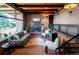 Comfortable living room with brick walls, a cozy fireplace, and large windows offering natural light at 21868 Mountsfield Dr, Golden, CO 80401