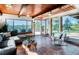 Cozy living room with large windows offering scenic views, comfortable seating, and unique ceiling at 21868 Mountsfield Dr, Golden, CO 80401