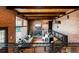 Comfortable living room with brick walls, a cozy fireplace, and railings overlooking downstairs at 21868 Mountsfield Dr, Golden, CO 80401