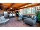 Comfortable living room with tile flooring, large windows with scenic views, and wood ceiling at 21868 Mountsfield Dr, Golden, CO 80401