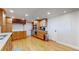 Modern kitchen with wood cabinets, wine rack, and hardwood floors at 1777 Larimer St # 1608, Denver, CO 80202