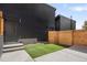 Private backyard with artificial turf and a wood fence for privacy at 1266 N Stuart St # 2, Denver, CO 80204