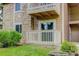 Charming balcony off unit K105 with white railings and greenery creates a welcoming outdoor space at 4400 S Quebec St # 105K, Denver, CO 80237
