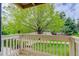 Balcony view overlooking green grass, landscaping, walking path, and mature shade trees at 4400 S Quebec St # 105K, Denver, CO 80237