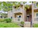 Inviting condo with stone and siding exterior, plus a charming balcony and well-maintained landscaping at 4400 S Quebec St # 105K, Denver, CO 80237