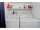 Close up of washer and dryer with shelving for storage in the convenient laundry area at 4400 S Quebec St # 105K, Denver, CO 80237