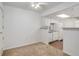 Open-concept living space with carpet, adjacent kitchen, white appliances, and lots of light at 4400 S Quebec St # 105K, Denver, CO 80237