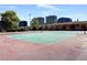 A full size tennis court with buildings in the background provides residents the ability to play tennis at 4400 S Quebec St # 105K, Denver, CO 80237
