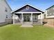 Beautiful backyard with a covered patio and a well-maintained lawn at 4940 Akron St, Denver, CO 80238