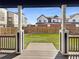 View of fenced backyard and artificial grass from patio and architectural columns at 4940 Akron St, Denver, CO 80238