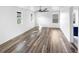 Large open room with a ceiling fan, light from three windows, and wood floors at 4940 Akron St, Denver, CO 80238