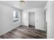 Bedroom with closet and bright window providing natural light and gray wood floors at 4940 Akron St, Denver, CO 80238