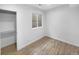 This bedroom features wood-look floors and a basement window at 4940 Akron St, Denver, CO 80238