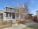 Charming two-story home with a welcoming front porch and manicured landscaping at 4940 Akron St, Denver, CO 80238