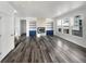 Bright living room featuring hardwood floors, built-in shelves, and a modern fireplace at 4940 Akron St, Denver, CO 80238
