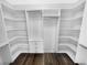 Spacious walk-in closet with custom shelving, drawers, and hanging rods for optimal organization at 4940 Akron St, Denver, CO 80238