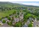Aerial view of neighborhood, showcasing tree-lined streets and lush green landscape with mountain backdrop at 18 Blue Sage, Littleton, CO 80127
