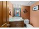 Charming half-bathroom with a marble sink and decorative turtle accent at 18 Blue Sage, Littleton, CO 80127