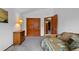 Comfortable bedroom with a wood dresser, closet, and bed, providing ample space and storage at 18 Blue Sage, Littleton, CO 80127